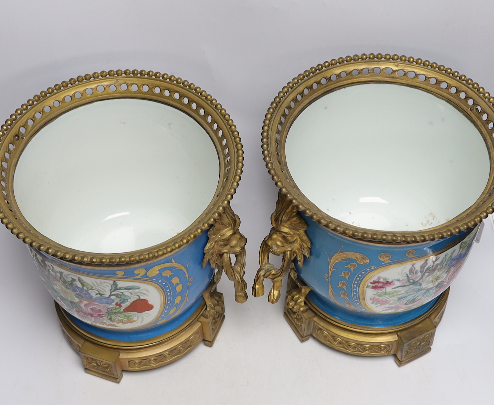 A pair of ormolu mounted Sevres style cache pots, 29cm high